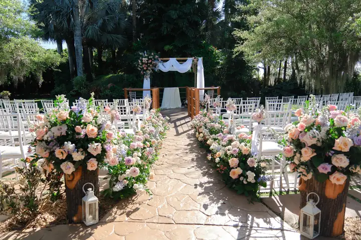 Outdoor garden ceremony aisle with flowers