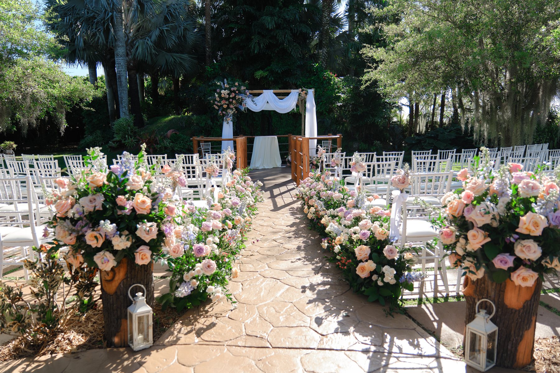 Outdoor garden ceremony aisle with flowers