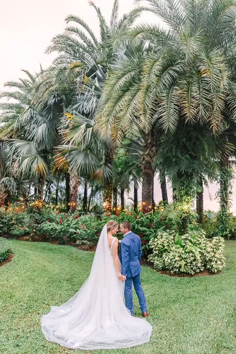 Couple portrait among Longan’s Place palm trees
