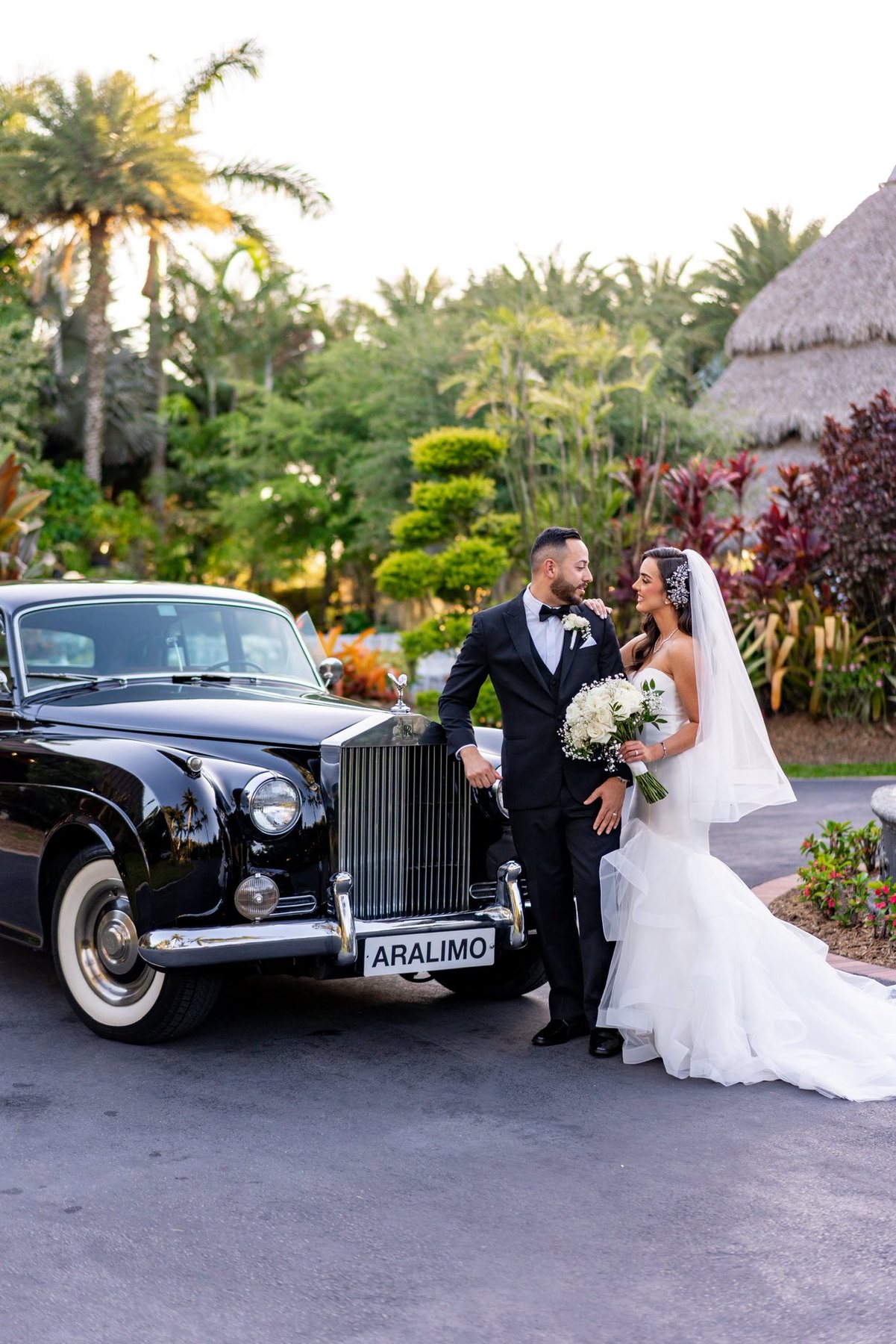 Couple with classic wedding car