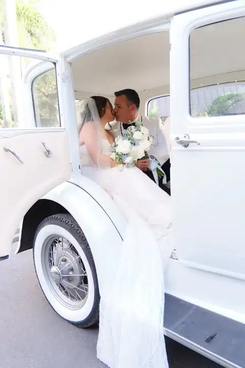 Bride in vintage white car