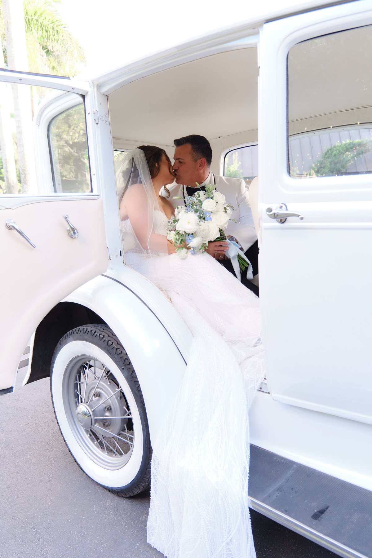 Bride in vintage white car